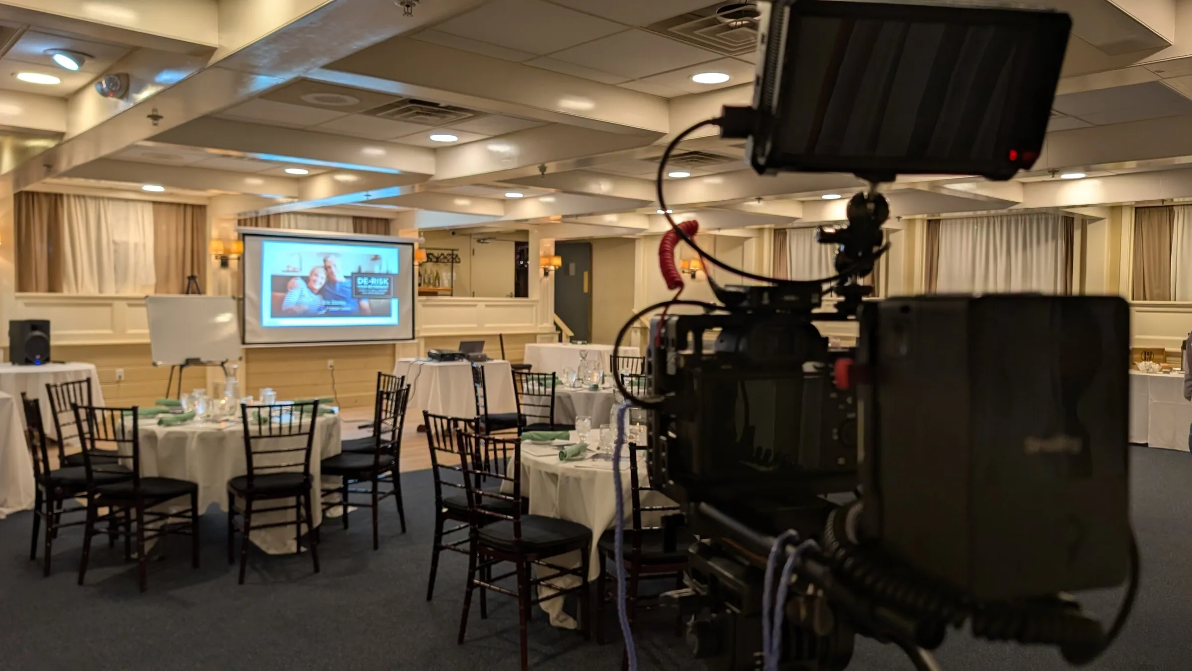 Camera set up at the back of a banquet hall before an event